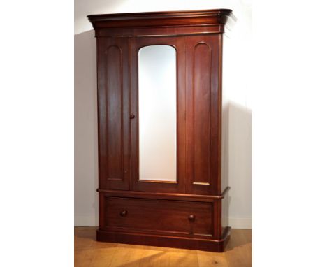 A VICTORIAN MAHOGANY WARDROBEthe moulded pediment over a single mirror panelled door opening to an interior fitted with a han