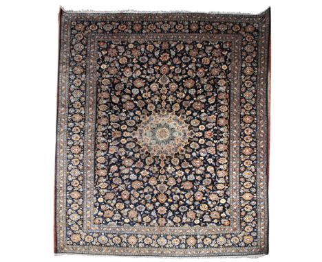 A PERSIAN KASHAN CARPETwoven in light blue and other colours with central circular medallion and all over scrolled leaf ornam