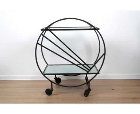 AN ART DECO STYLE DRINKS CARTmid-century modern, the black metal circular outline with sunray detail to one side, two rectang