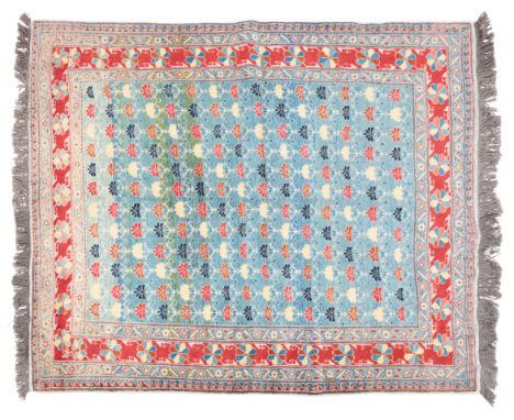A QASHGAI RUGwoven with central light blue ground with stylised flowers in reds, yellows and indigos, with red outer edge and