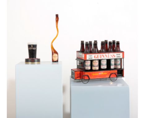 A GUINNESS METAL OMNIBUS CART BY SHOWCARD CO. LTD circa 1960s, with empty stout bottles within the crate, 27cm high x 49cm lo