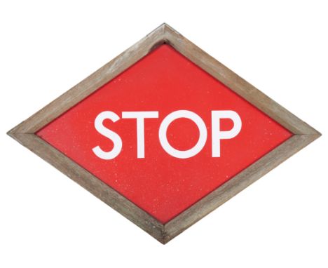 A RED ENAMEL RHOMBUS SHAPED 'STOP' ROAD SIGN mounted in oak frame, 54cm x 75cm approx. (excluding frame)