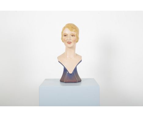 AN ART DECO PLASTER SHOP MANNEQUIN BUST OF A BLONDE BOBBED 'FLAPPER'realistically modelled with blue eyes, rouged cheeks and 