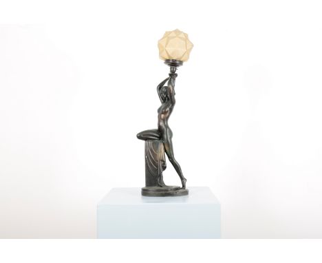 AN ART DECO PLASTER OR CHALKWARE FIGURAL LAMP the naked lady resting on plinth with drapery, holding the multi-faceted opaque