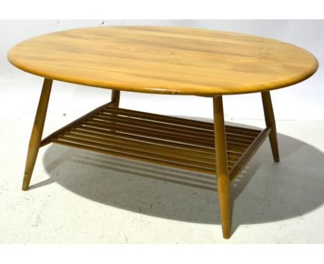 Ercol style occasional coffee table,  circa 1985, elm and beech, oval top above a spindle magazine rack, applied label "Caves