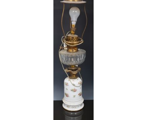 Porcelain and gilt metal mounted oil lamp, the base painted with floral sprigs, cut glass reservoir marked Hinks & Sons paten