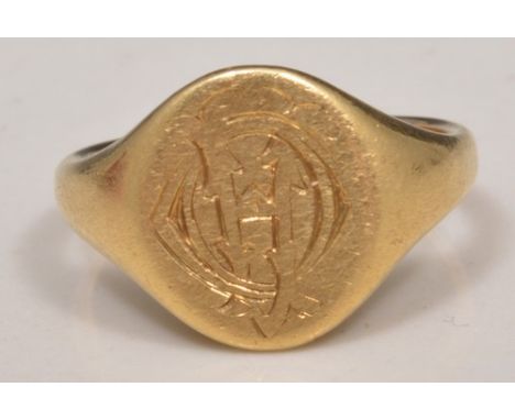 Yellow metal signet ring, engraved monogram and indistinctly back engraved.
