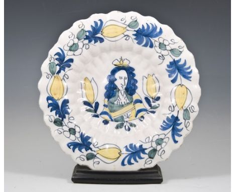 A Dutch Delft polychrome lobed circular dish, late 17th Century with a painted portrait of King William of Orange surrounded 