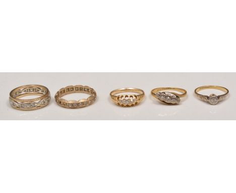 18ct gold and platinum five stone ring, a synthetic white spinel ring, a single stone ring and two eternity rings (5).