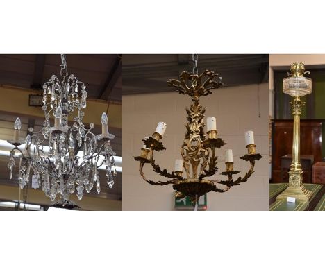 A five branch Rococo style ormolu chandelier, a brass Corinthian oil lamp, and a modern six branch chandelier (3)