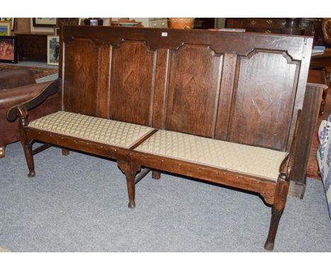 A George III oak four panel settle, 187cm by 60cm by 110cm 