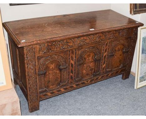 An 18th century oak three panel coffer, carved and with marquetry inlay, 117cm by 49cm by 63cm 