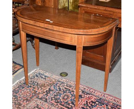 An early 19th century mahogany foldover card table banded in satinwood, with brass stringing and square tapering supports, 92