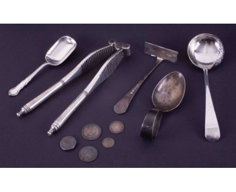 A silver baby pusher, silver and pierced ladle spoon and two silver caddy spoons and a pair of silver nut crackers (61.6g) (5