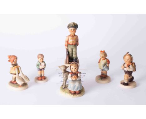 A collection of six Hummel figurines and stand.