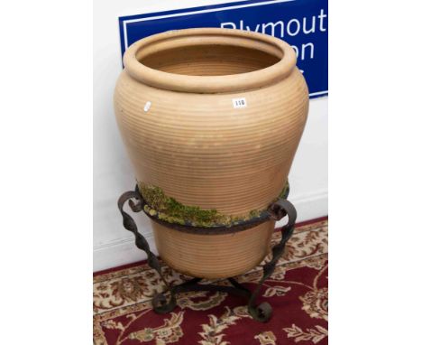A large Terracotta planter on iron base (used condition), height 78cm.