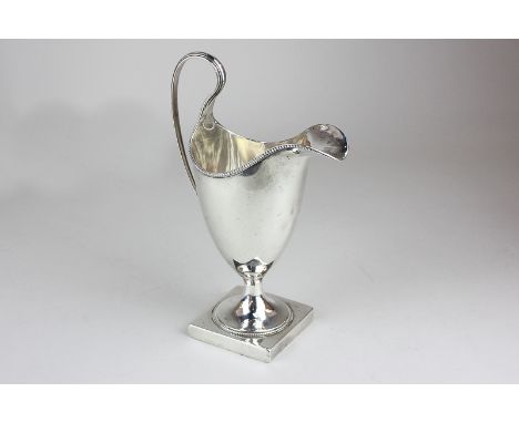 A George III silver cream jug, helmet shape with gadroon border, by Hester Bateman, London 1789, 5oz