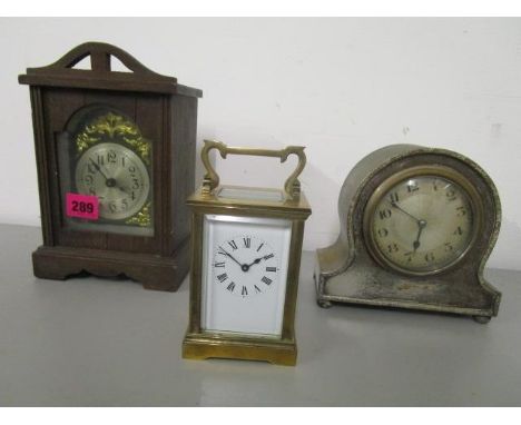 Clocks to include a silver plated, cased Edwardian mantle clock, a wooden cased mantle clock and a brass cased five window ca