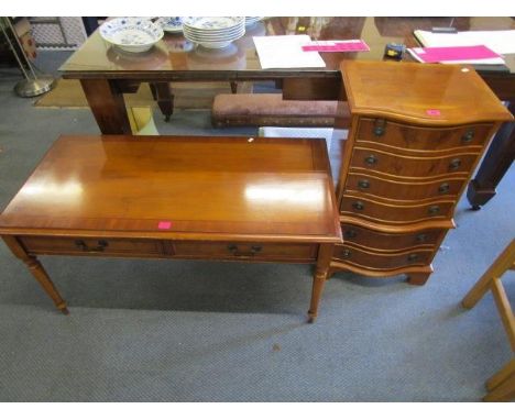 A yew wood serpentine fronted bedside chest of six drawers on bracket feet and a yew wood coffee table, two frieze drawers on