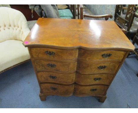 A walnut and mahogany crossbanded chest of drawers, serpentine fronted on bracket feet, 32" x 29 6/8" x 18 6/8" 