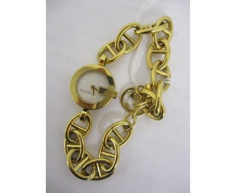 A Gucci gilded stainless steel ladies' quartz wristwatch with mother of pearl dial having floral decoration, with original Gu