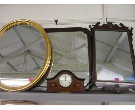 A group of three wall mirrors and an Edwardian inlaid mahogany mantle clock 