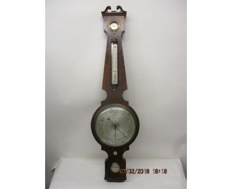 An early 19th century mahogany wheel barometer with a swan neck pediment, over a dry/damp, thermometer, a silvered dial and a