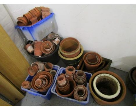 A large quantity of terracotta flower pots and ceramic jardinieres 