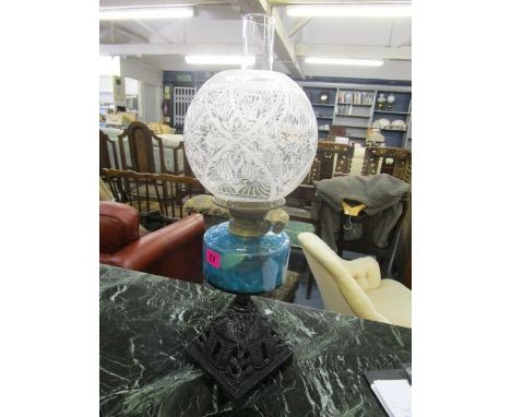 A Victorian English Duplex 1 1/16" wick double burner oil lamp with painted, cast iron base, light blue glass reservoir, acid