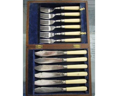 An oak cased set of six fish knives and forks with simulated ivory handles and silver bands, hallmarked Sheffield 1920, cased