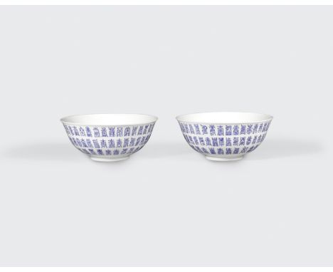 A pair of glazed porcelain bowls with blue enamel shou characters19th centuryEach molded with a flared rim to the wide well a