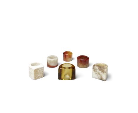 Six archer's ringsThe first three of cylindrical shape carved from jadeite displaying patches of reddish brown; the fourth ca