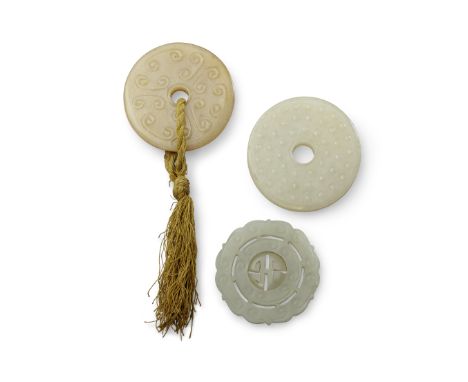 Three jade decorationsQing DynastyIncluding two circular plaques with raised c-scroll patterns reversed by raised circular bo