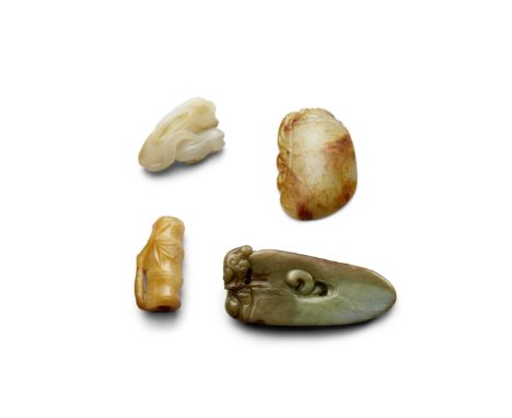 Four small mottled jade carvingsThe first a pendant carved as an archaistic axe head topped by a recumbent chilong, the pale 