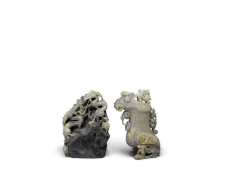 Two carved hardstone decorationsThe first a mottled gray and white jade landscape rock carved with two dragons contending for