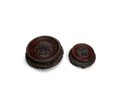 Two circular stands with dragonsEach of circular form, the first with the top surface reticulated to show a dragon pursuing a