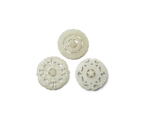Three circular jade pendantsIncluding two similarly undercut with two pairs of facing dragons surrounding a bi-disc engraved 