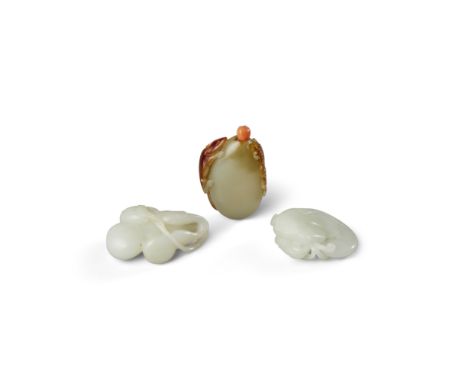 Three jade carvingsThe first carved as a gourd issuing from a leafy stem alongside smaller gourds, the matrix a pale hue; the