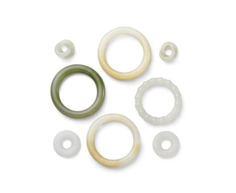A group of jade jewelryIncluding a pair of earrings, each deeply undercut as two interlocking rings of greenish-white jade;  