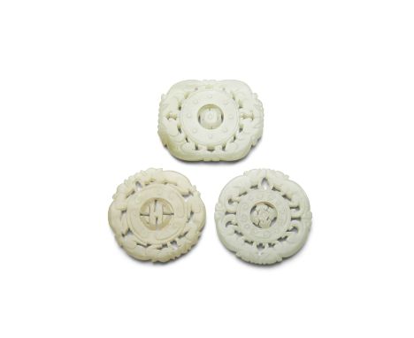 Three jade pendants reticulated with dragon bordersIncluding two of circular format, the paired dragons on one surrounding a 