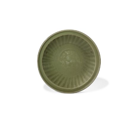 A Longquan celadon dishMing dynasty Thickly molded with a ribbed cavetto and a central well impressed with a chrysanthemum sp