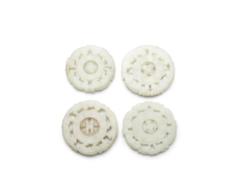 Four circular jade pendantsSimilarly undercut with pairs of facing dragons surrounding a bi-disc engraved with C-scrolls, one
