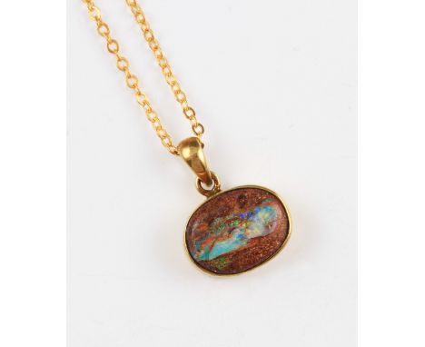 A boulder opal pendant, rub over set in a silver gold plated mount, suspended from a gold plated belcher chain, total weight 