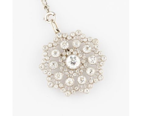 A Belle Epoque style white metal and diamond pendant, set with a central round old cut diamond, approx. 0.44ct, with repeat o