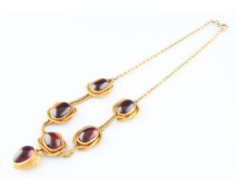 A Victorian yellow metal garnet necklet, with a heart shaped dropper pendant set with a tear shaped garnet carbuncle with scr