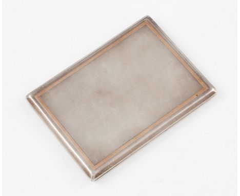 A silver rectangular cigarette case with machined design with lid having a gold coloured frame with gilt interior, hallmarked