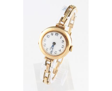 A 9ct yellow gold cased ladies wrist watch, the white enamel dial having hourly Arabic numeral markers with minute track bord
