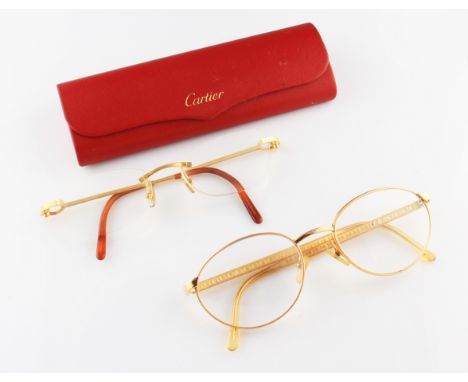A pair of glasses by Cartier, with yellow metal arms and bridge, shape 135, housed in original case and box with paperwork, t