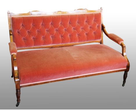 A late Victorian rosewood framed and inlaid salon settee with button backed upholstery and turned supports, length 120cm.