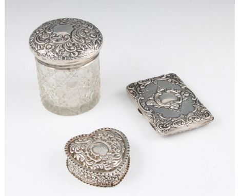 A group of three silver items to include card case with ornate scroll design with scroll and foliage design cartouches with f